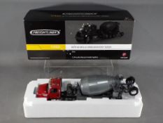 First Gear - A boxed 1:34 scale Freightliner 114SD with McNeilus Bridgemaster Mixer by First Gear.