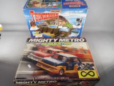 A boxed Matchbox Thunderbirds Tracy Island playset and a boxed Scalextric Mighty Metro racing set,