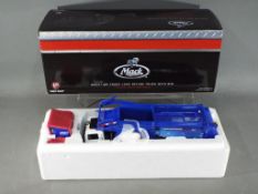 First Gear - A boxed 1:34 scale Mack MR Front Load Refuse Truck with Bin by First Gear.