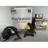 A boxed Sony Playstation games console with instructions and controller,
