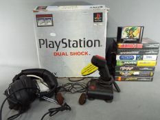 A boxed Sony Playstation games console with instructions and controller,