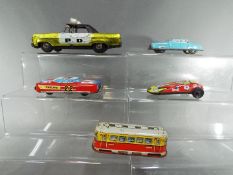 A group of tinplate vehicles to include a West German model of a tram, Nakamura Toys racing car,