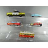 A group of tinplate vehicles to include a West German model of a tram, Nakamura Toys racing car,