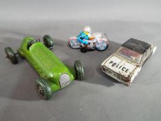 Mettoy - a Mettoy friction car, a tinplate police motorbike and a police car.