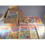 A box containing a quantity of vintage comics including Beezer, Topper,