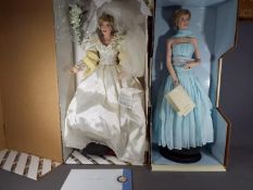 Two Franklin Mint Princess Diana porcelain collectors dolls contained in original boxes and