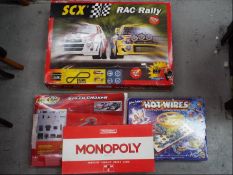Scalextric, SCX, Waddingtons and Others - A group of two boxed slot car racing games,