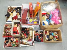 A large collection of 9 boxes of predominately vintage dolls and soft toys.