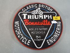 A cast iron Triumph wall plaque (ymctr)