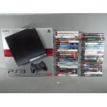 Playstation - A boxed Sony Playstation 3 games console and a large quantity of PS3 games.