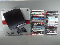 Playstation - A boxed Sony Playstation 3 games console and a large quantity of PS3 games.