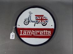 A circular Lambretta wall plaque,