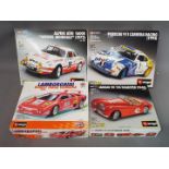 Bburago - Four diecast model kits by Bburago in various scales.