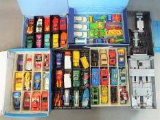 A collection of approximately 75 unboxed diecast model motor vehicles contained in collector's