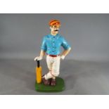 A cast iron cricketer doorstop,