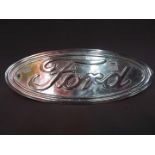 A chrome sign advertising Ford motor cars