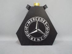 A black petrol can advertising Mercedes Benz