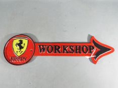 A cast iron arrow workshop sign, Ferrari,