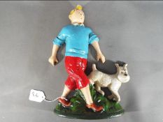 A cast iron doorstop depicting Tintin and his dog (xdstt),