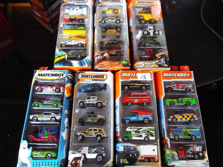 Matchbox on a Mission, Mattel seven sealed packs each containing five model motor vehicles,