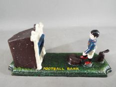A cast iron novelty money bank depicting a footballer (xbfb)