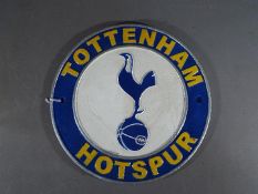 A circular cast iron Tottenham Hotspur wall plaque,