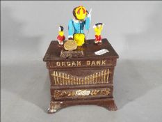 A cast iron novelty organ money bank (xborg)