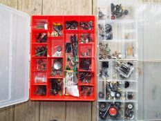 Three plastic compartmentalised cases each containing a good selection of model parts, wheels, nuts,
