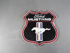 A cast iron Ford Mustang wall plaque,