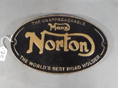 A cast iron oval Manx Norton wall plaque (ymcnm) approx 20 x 33 cm