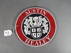 A circular cast iron Austin Healey sign,