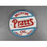A circular cast iron Pratts oil wall plaque,