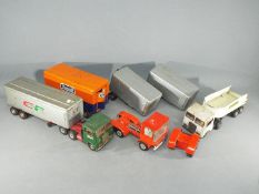 A small collection of Japanese and possible European tinplate commercial vehicles and trailers Lot