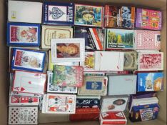 A large collection of approximately 200 vintage and retro packs of playing cards and games.