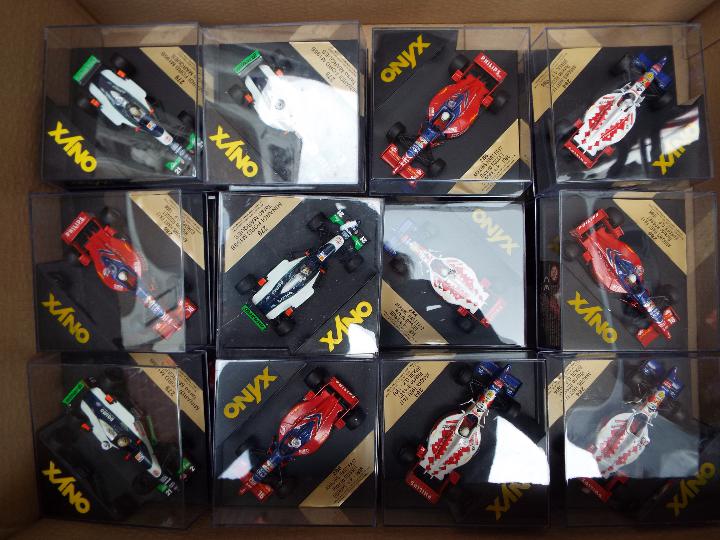 Onyx - 23 diecast model F1 racing cars with driver figures in square rigid transparent cases,