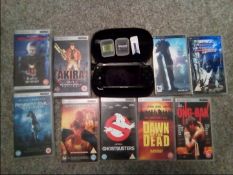 Gaming - a PSP hand-held games console with carry case and nine PSP movies (all sleeves contain