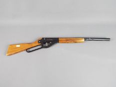 Daisy - An unboxed Daisy Red Ryder cork firing toy gun in Playworn condition.