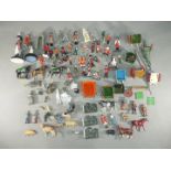 Britains - A quantity of unboxed military and civilian figures with some farm implements,