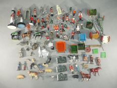 Britains - A quantity of unboxed military and civilian figures with some farm implements,