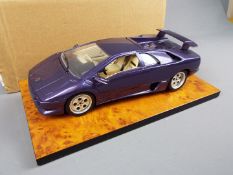 Bburago - A boxed 1:18 scale Lamborghini Diablo in metallic purple.