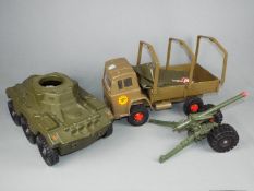 Cherilea - An unboxed Military Supply Truck and Scout Car by Cherilea with an unboxed artillery gun