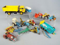 Britains, Corgi Toys - a collection of 15 unboxed diecast farm vehicles and implements.
