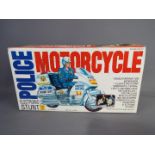 Min Yin - A vintage boxed plastic Police Electronic Stunt Motorcycle by Min Yin Toys .