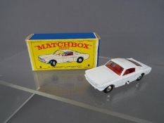 Matchbox by Lesney - Ford Mustang, white body with red interior, black plastic wheels,