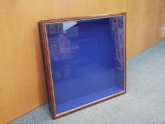 A wooden wall mounted display cabinet with glass opening door and three glass shelves,