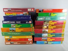 Nineteen jigsaw puzzles in original boxes, unchecked for completeness.