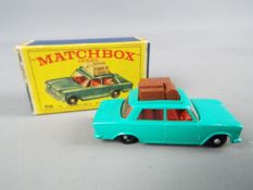 Matchbox by Lesney - Fiat 1500, metallic green body with roof rack and luggage, red interior,