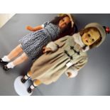 Dolls - A pair of tall walking dolls consisting of a female brunette doll with a composition face,