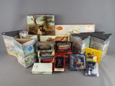 A mixed collection of boxed jigsaws, diecast vehicles and model soldiers.