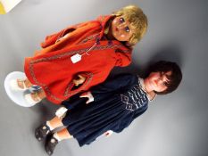 Dolls - A pair of large, tall walking dolls to include a female doll with hard celluloid head,